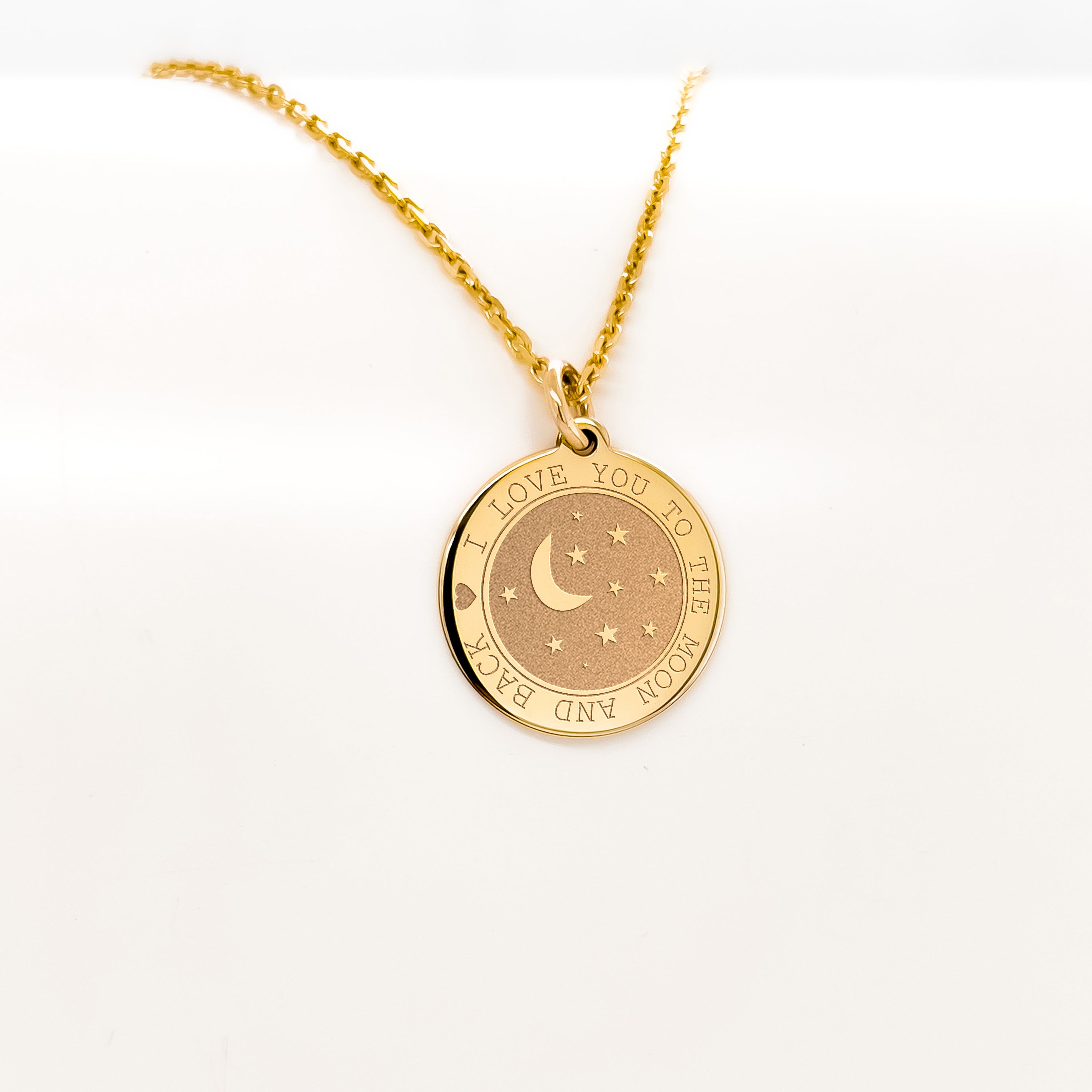 a gold necklace with a crescent and stars on it