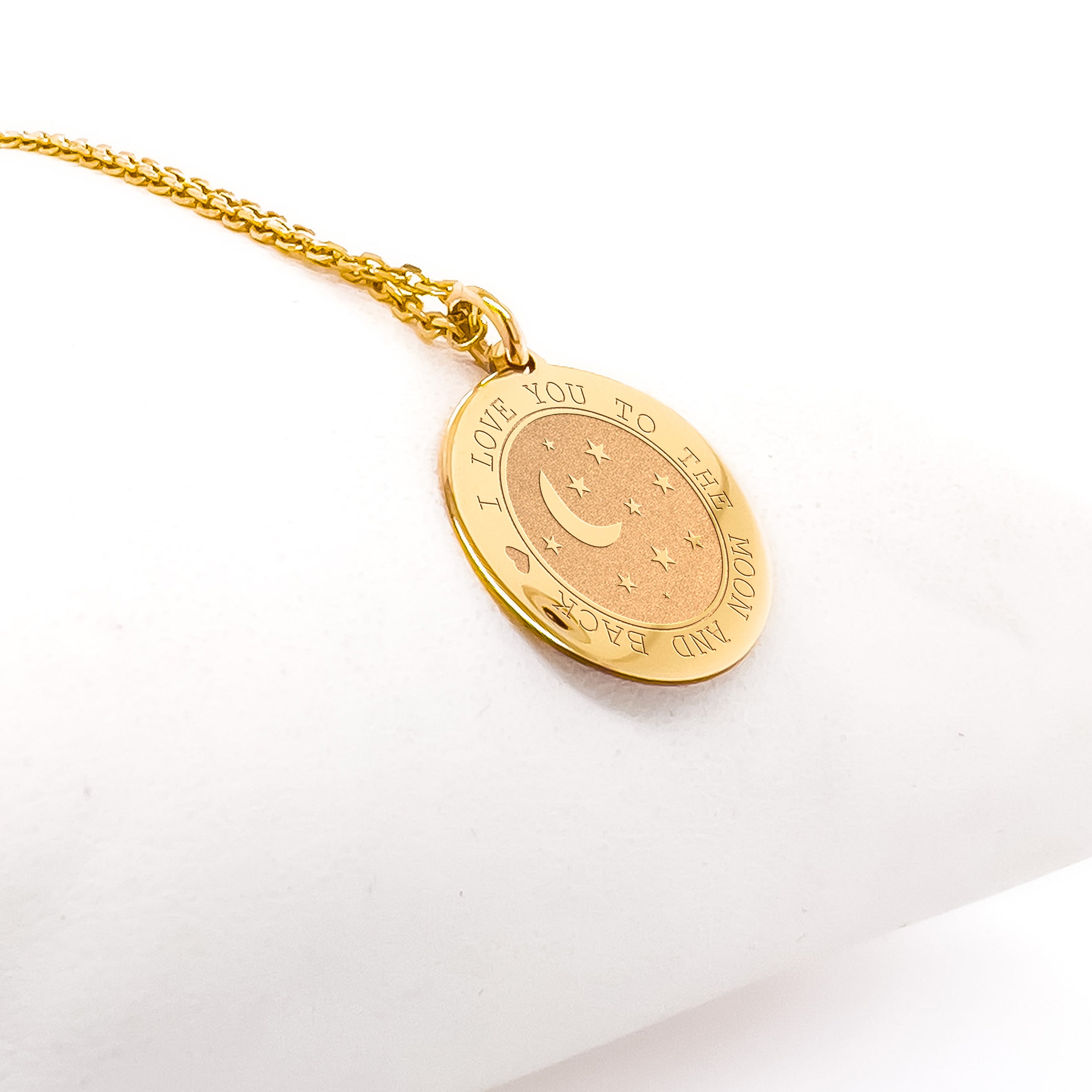 a gold necklace with a crescent and stars on it