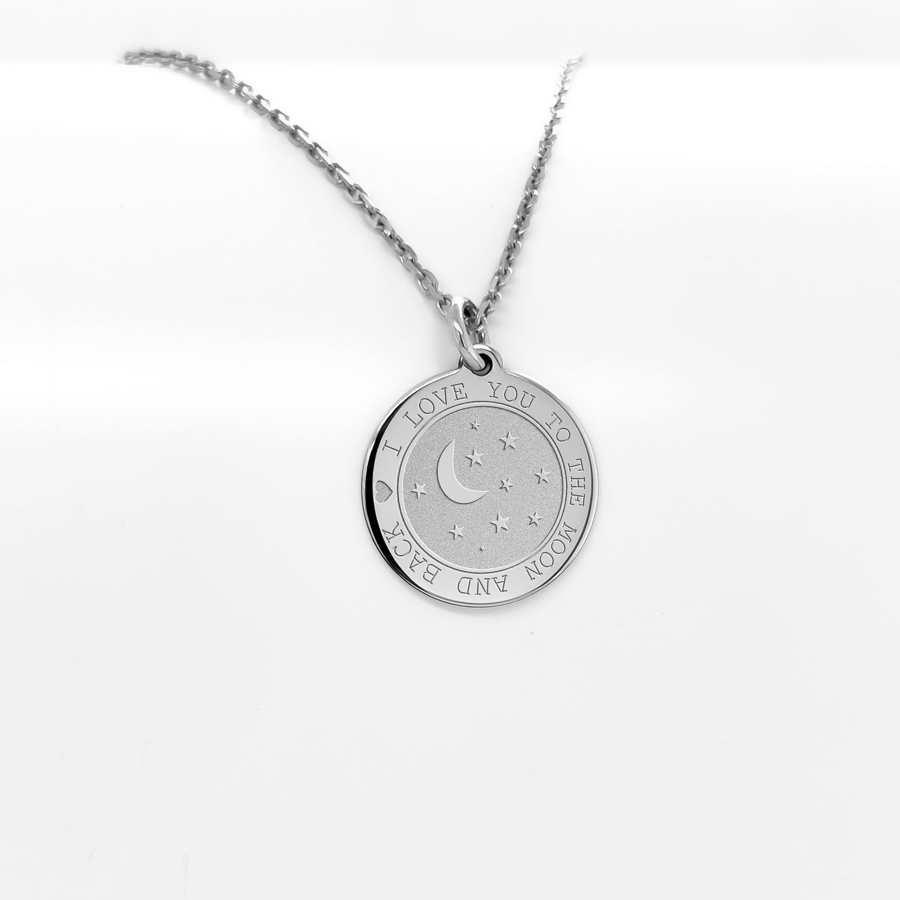 a silver necklace with a crescent and stars on it